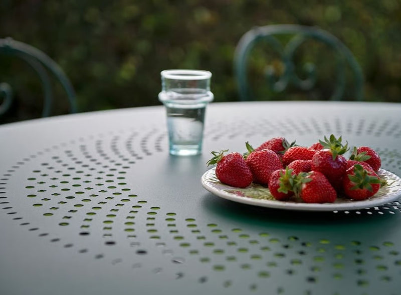 Load image into Gallery viewer, Fermob 1900 outdoor dining table with 96cm diameter round steel top and colorful painted finish in outdoor setting