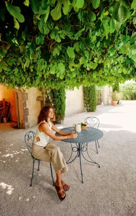 Load image into Gallery viewer, Fermob 1900 outdoor table with a 96cm diameter, featuring a round metal top and classic design for patio or cafe settings.