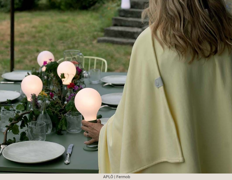 Load image into Gallery viewer, Fermob APLÔ Lamp H.24 with magnetic base, modern outdoor lighting fixture on a restaurant table, in black finish.