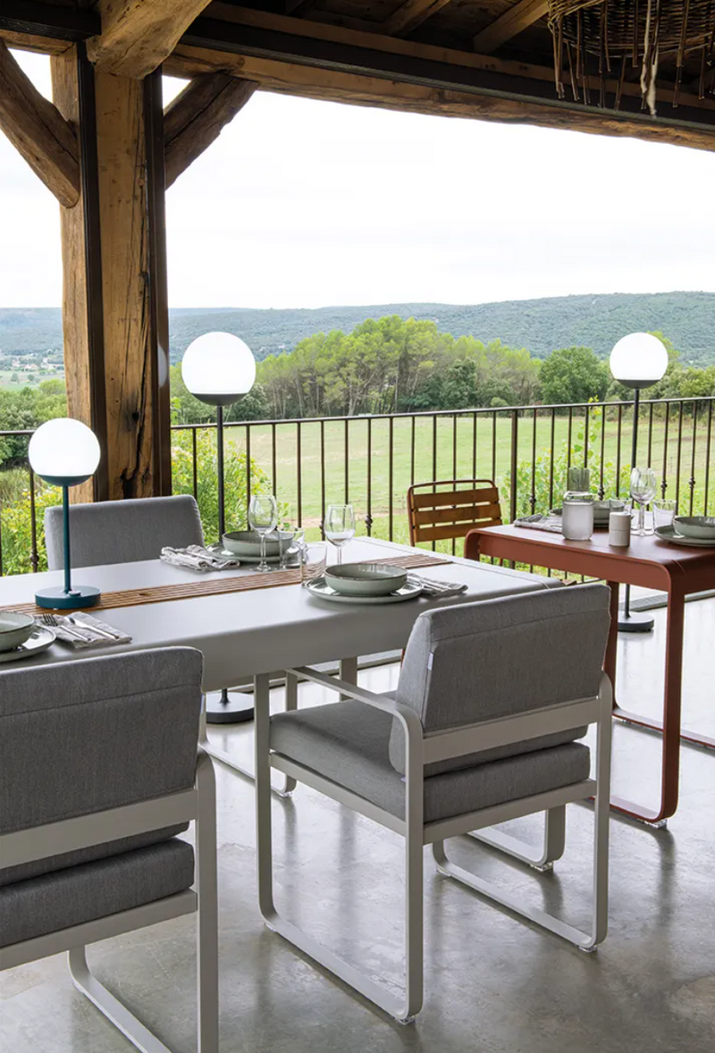 Load image into Gallery viewer, Fermob Bellevie outdoor dining armchair with a nutmeg grey toupet cushion and armrests, designed for comfortable outdoor seating.