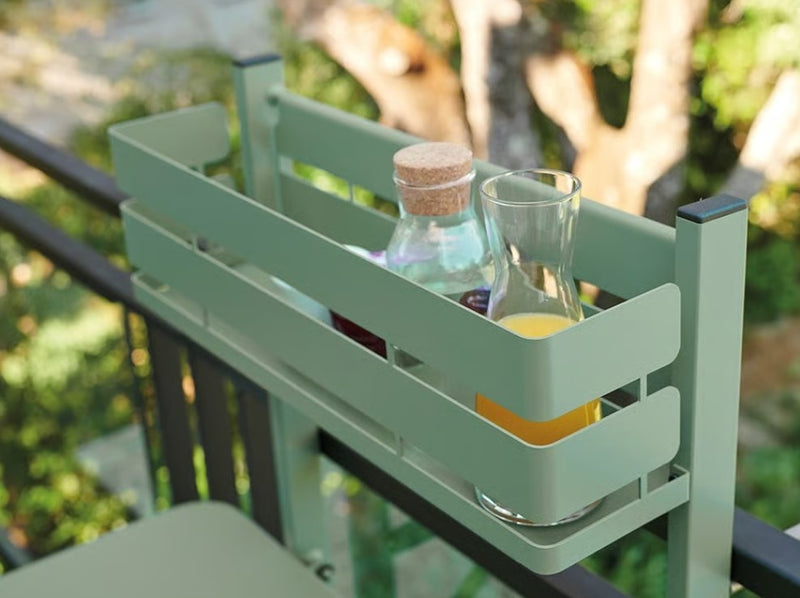 Load image into Gallery viewer, Fermob foldable bistro balcony table set up outdoors on a patio with a city view, ideal for small outdoor spaces.