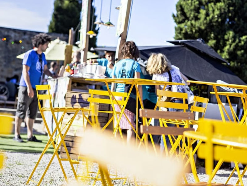 Load image into Gallery viewer, Fermob Bistro High Stool, a foldable bar chair with wooden seat and metal frame, suitable for outdoor hospitality settings.