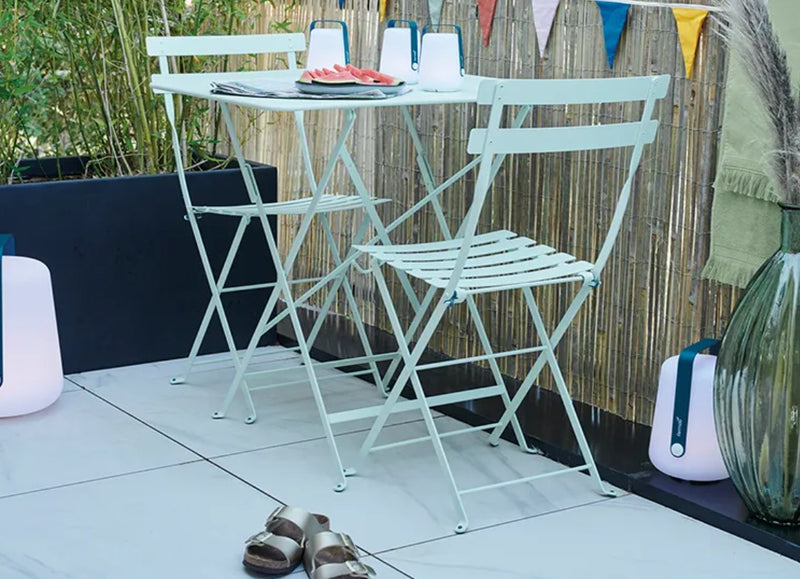 Load image into Gallery viewer, Fermob foldable bistro table measuring 77 x 57 cm, with a sleek design, ideal for restaurant or hospitality use.