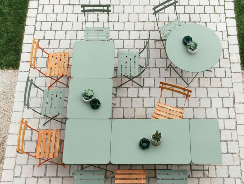Load image into Gallery viewer, Fermob foldable metal bistro table measuring 97x57 cm, with a hole for outdoor dining, ideal for hospitality and hotel use.