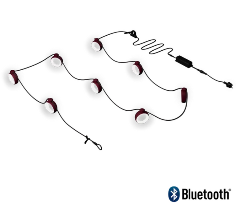 Load image into Gallery viewer, Fermob HOOPIK black cherry string lights, 1200 cm outdoor lighting for restaurant or hotel ambiance in a nighttime setting.