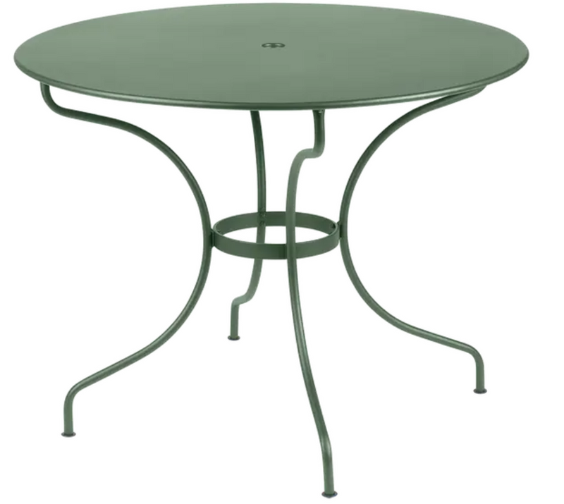 Load image into Gallery viewer, Fermob OPÉRA+ outdoor metal table with 96cm diameter, suitable for five people, shown on a patio setting.