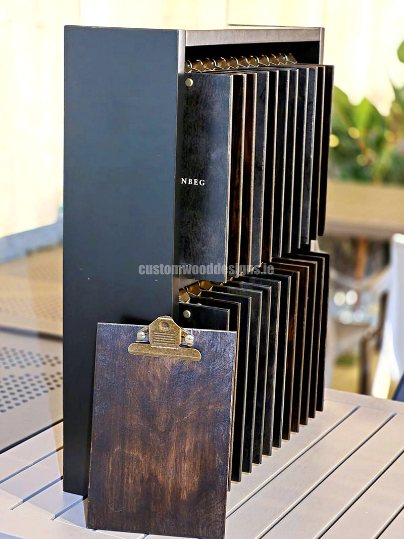Load image into Gallery viewer, Set of 24 branded A5 wooden clipboards with display unit from Custom Wood Designs, ideal for hospitality and hotel menus.