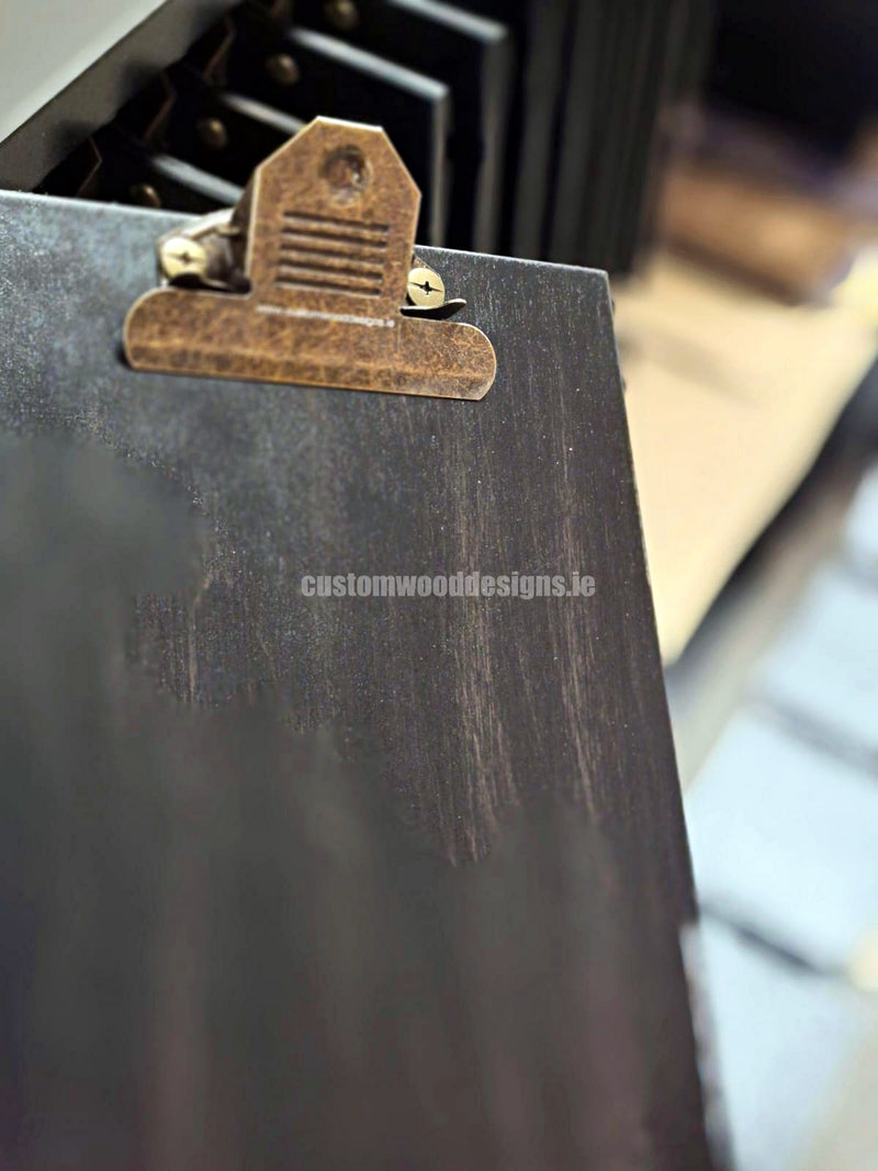 Load image into Gallery viewer, Set of 24 premium branded A5 wooden clipboards with Custom Wood Designs logo, displayed on a hospitality and cafe menu stand.