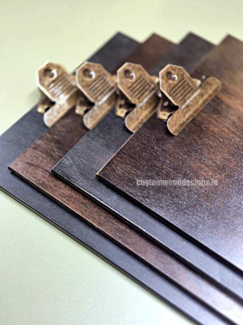Load image into Gallery viewer, Set of 24 branded wooden A4 clipboards by Custom Wood Designs, displayed on a hospitality or hotel menu setup.