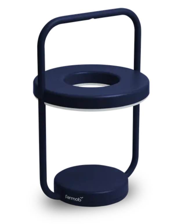 Load image into Gallery viewer, Fermob ULLI Monochrome outdoor lamp in deep blue, 30 cm height, illuminated and charging for outdoor lighting ambiance.