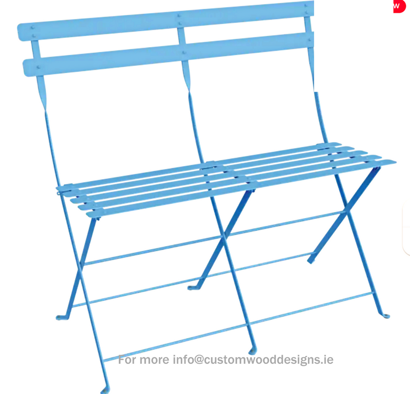 Load image into Gallery viewer, Maya blue Fermob Bistro two-seater folding ottoman used as a bench, with a smooth, vibrant blue finish and wooden legs.
