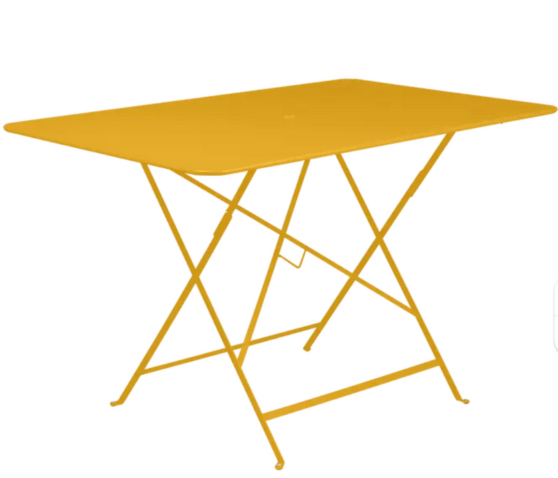 Load image into Gallery viewer, Fermob honey-colored foldable bistro table measuring 117 x 77 cm, outdoor metal furniture, shown in a garden setting.
