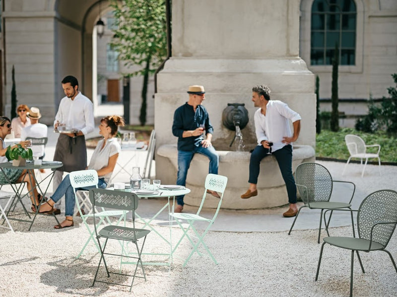 Load image into Gallery viewer, Fermob Lorette outdoor metal chair with a stylish, curved design for hospitality, restaurant, or outdoor living spaces.