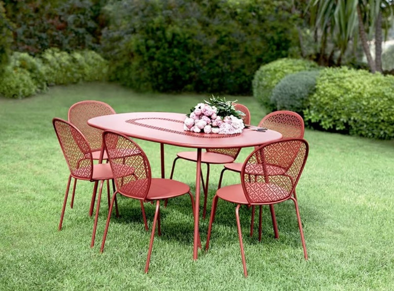 Load image into Gallery viewer, Fermob Lorette oval metal table, 160x90 cm, shown outdoors in a hospitality setting with a modern design.