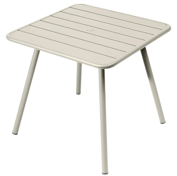 Load image into Gallery viewer, Fermob Luxembourg 4-leg garden table, 80x80 cm, beige aluminum with a modern design for outdoor use.