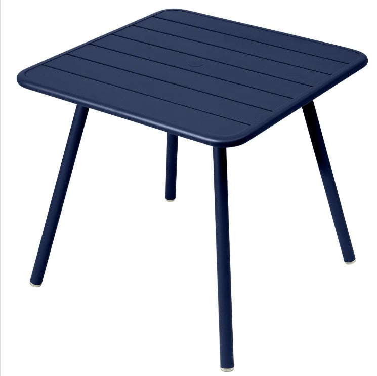 Load image into Gallery viewer, Fermob Luxembourg 4-leg garden table in blue and black metal, 80x80 cm, outdoor aluminum furniture with modern design.
