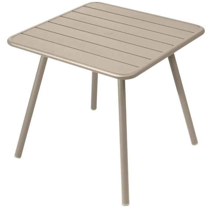 Load image into Gallery viewer, Fermob Luxembourg 4-leg garden table, 80x80 cm, dark beige aluminum with a sleek modern design for outdoor use.