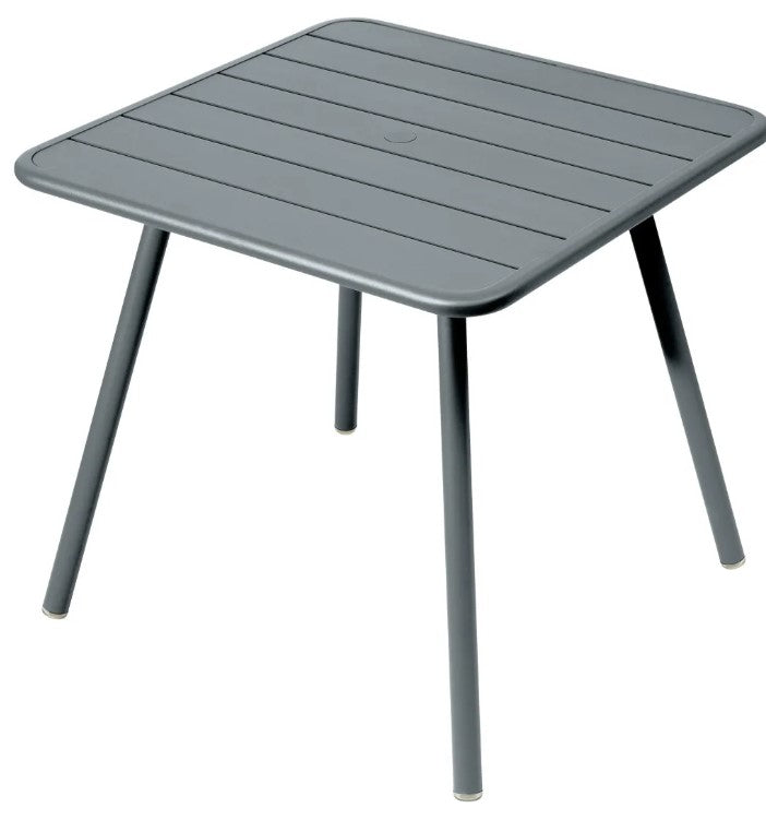 Load image into Gallery viewer, Fermob Luxembourg 4-leg garden table in dark steel metal, 80x80 cm, with a sleek aluminum finish and modern design.