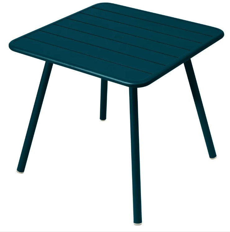 Load image into Gallery viewer, Fermob Luxembourg 4-leg garden table, 80x80 cm, dark teal aluminum with a sleek, modern design for outdoor dining.