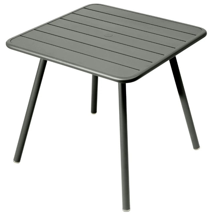 Load image into Gallery viewer, Gray-green Fermob Luxembourg 4-leg metal garden table, 80x80 cm, with a sleek aluminum surface and sturdy design.