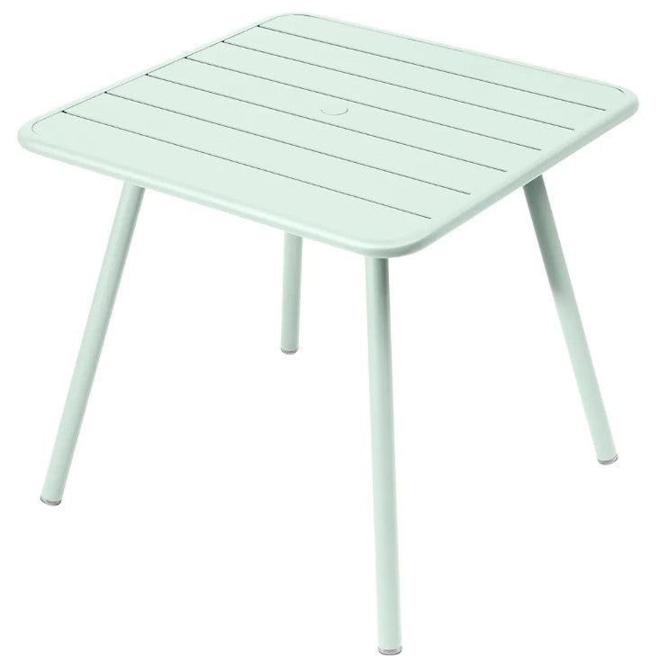 Load image into Gallery viewer, Fermob Luxembourg 4-leg garden table in aluminum, 80x80 cm, featuring a mint-colored metal surface for outdoor dining and decor.