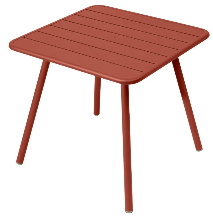 Load image into Gallery viewer, Fermob Luxembourg 4-leg garden table, 80x80 cm, metal with ochre aluminum finish, outdoor furniture for patio or garden.