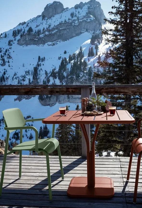 Load image into Gallery viewer, Dark red Fermob Luxembourg outdoor pedestal table, 80x80 cm, showing a sturdy terracotta-colored metal table for outdoor use.
