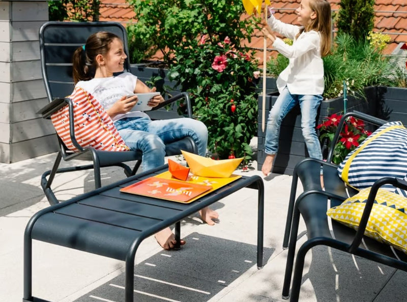Load image into Gallery viewer, Black Fermob Luxembourg outdoor rocking chair with a sleek metal frame and curved design for comfortable outdoor seating.