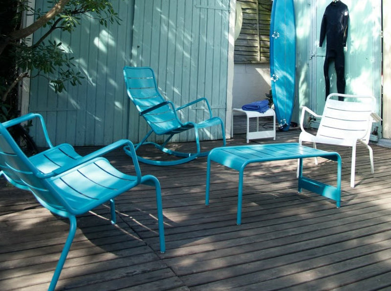 Load image into Gallery viewer, Blue Fermob Luxembourg outdoor rocking chair with metal frame and curved armrests, suitable for garden or patio seating.