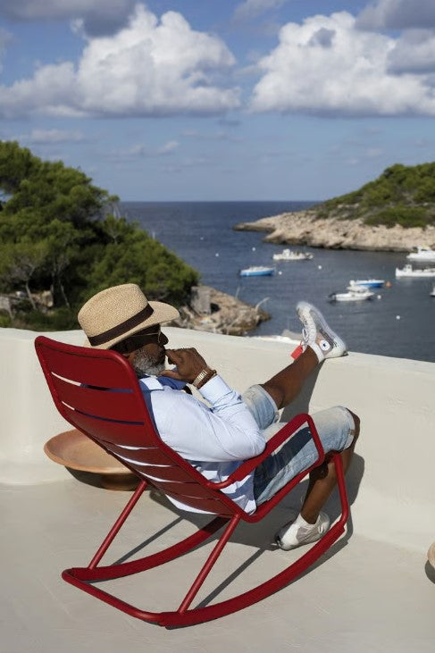 Load image into Gallery viewer, Red Fermob Luxembourg outdoor rocking chair with metal frame, featuring a stylish and comfortable design for outdoor relaxation.