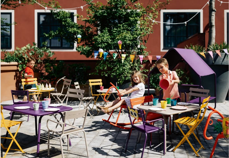 Load image into Gallery viewer, Fermob Luxembourg kids' children's table with a smooth surface and colorful legs, ideal for play and learning activities.