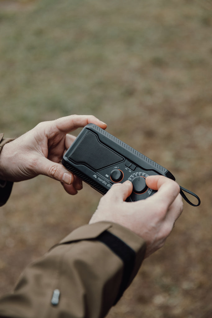 Load image into Gallery viewer, Nordic Drift Titan IPX4 multifunctional radio with 4000mAh battery, compact audio device featuring buttons and digital display.