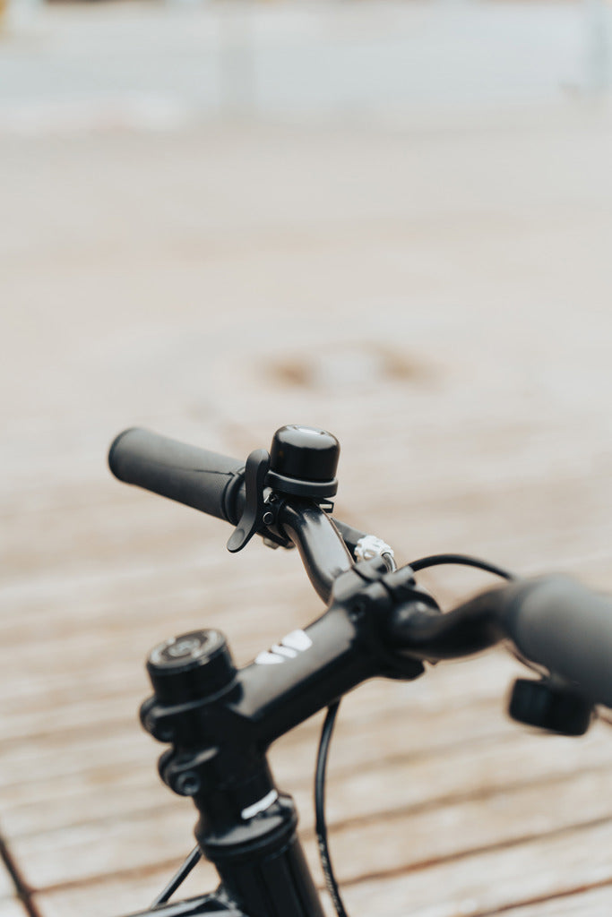 Load image into Gallery viewer, XD Collection Pedalfinder bike bell with worldwide locating feature, mounted on a bicycle handlebar, in a close-up shot.