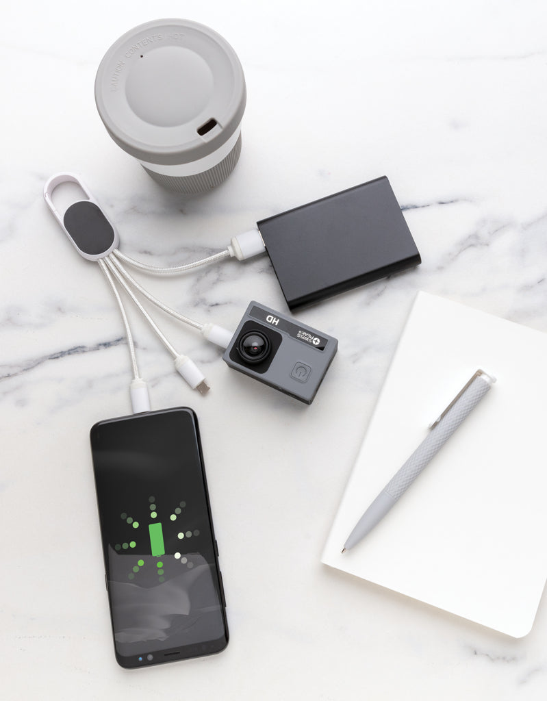 Load image into Gallery viewer, XD Collection 4-in-1 cable with carabiner clip for phone and tablet charging and data transfer, shown with connected devices.