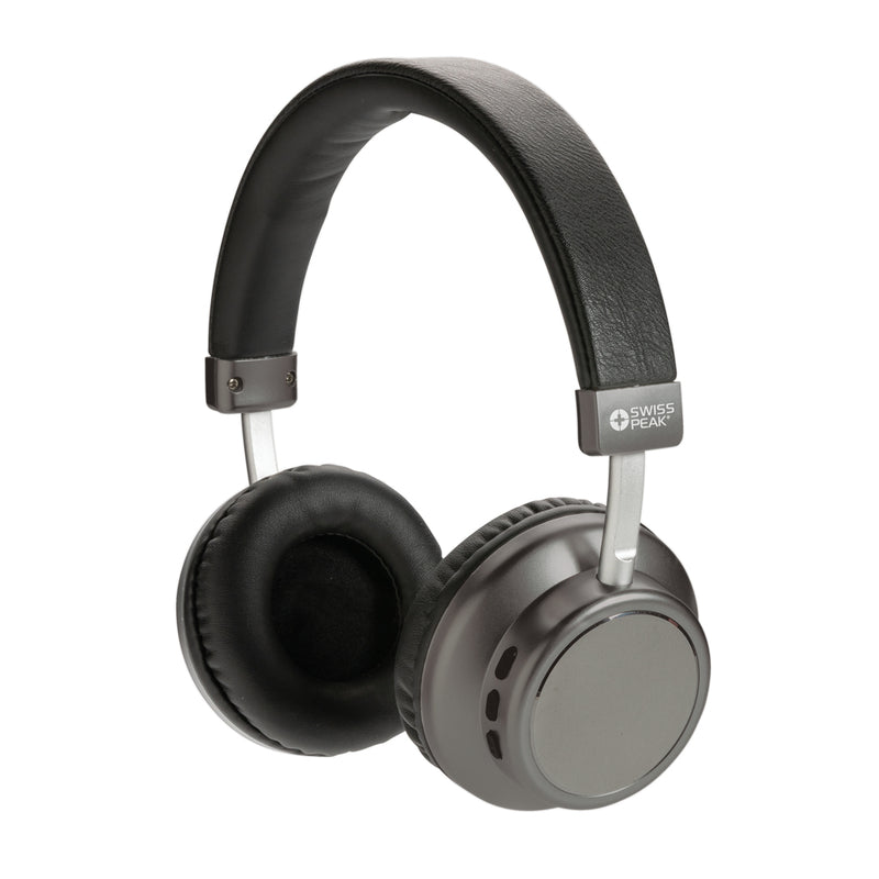 Load image into Gallery viewer, Wireless Swiss Peak V3 headphones in black with padded ear cups and headband, shown resting on a wooden surface.