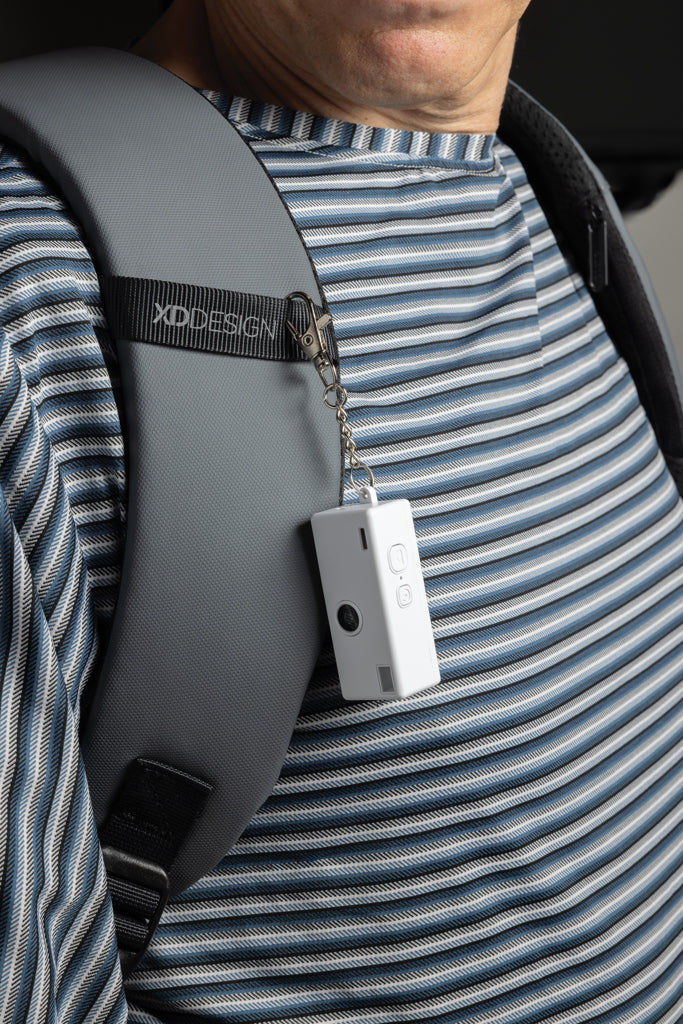Load image into Gallery viewer, XD Xclusive Cliq it RCS recycled keychain camera attached to a phone, showcasing portable phone and tablet accessory.
