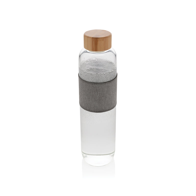 Load image into Gallery viewer, Borosilicate glass drinkware bottle with bamboo lid from XD Collection, featuring a clear glass body and natural bamboo cap.