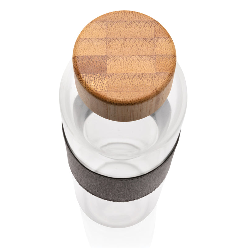 Load image into Gallery viewer, Borosilicate glass bottle with bamboo lid from XD Collection, clear drinkware for beverages, eco-friendly and stylish design