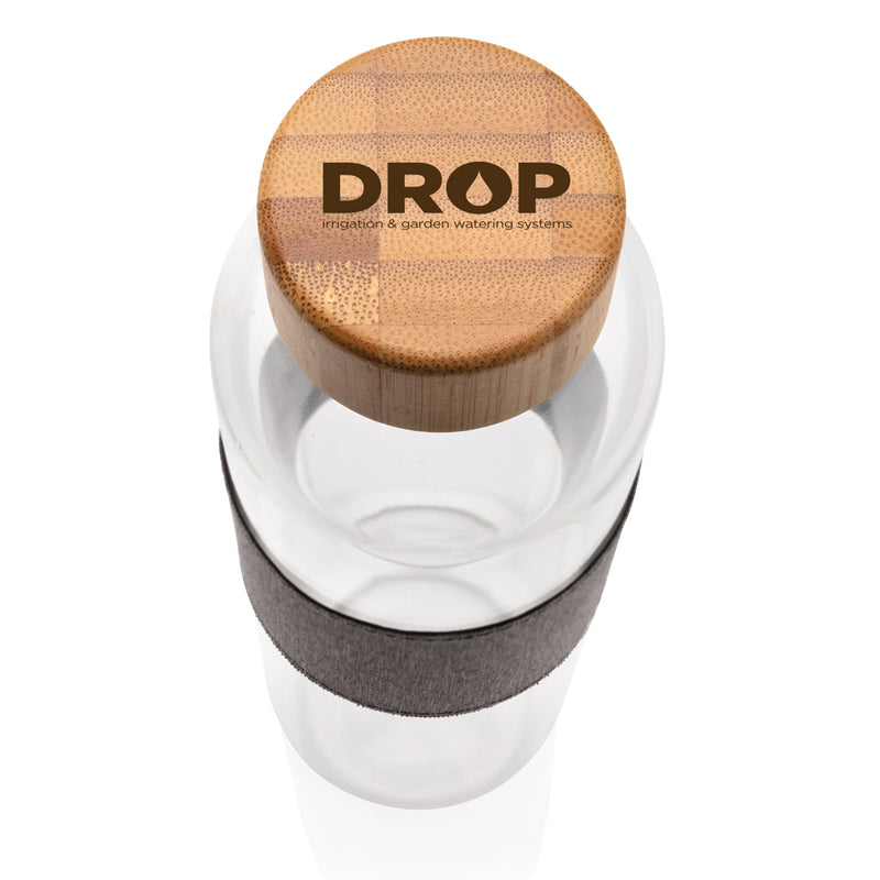 Load image into Gallery viewer, Borosilicate glass water bottle with bamboo lid, part of XD Collection drinkware, featuring a clear glass body and natural bamboo cap.