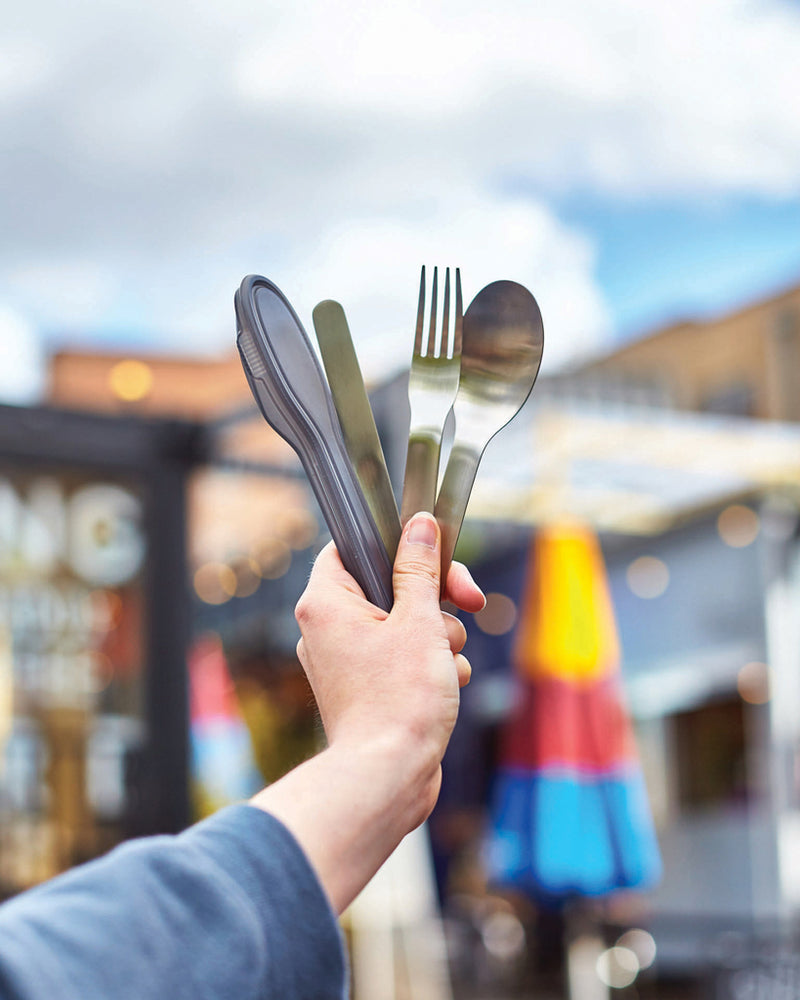 Load image into Gallery viewer, Black+Blum outdoor cutlery set with stainless steel knives, forks, and spoons arranged on a wooden surface.