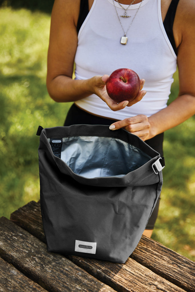 Load image into Gallery viewer, Black + Blum 6.7L insulated outdoor lunch and cooler bag with black exterior and adjustable shoulder strap.