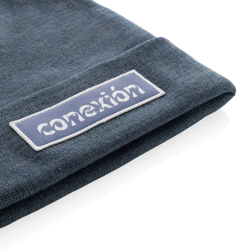 Load image into Gallery viewer, XD Collection Polylana® beanie headwear in neutral color, showcasing its soft, knitted fabric and snug fit.