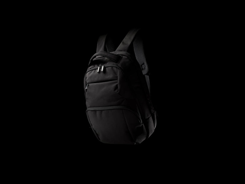 Load image into Gallery viewer, Impact AWARE™ Universal laptop backpack by XD Collection, showing the sleek black bag with multiple compartments and padded shoulder straps.