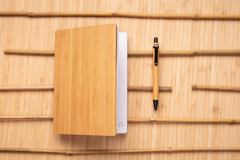 Load image into Gallery viewer, A5 bamboo notebook with matching pen from XD Collection, showcasing eco-friendly design and natural wood finish.
