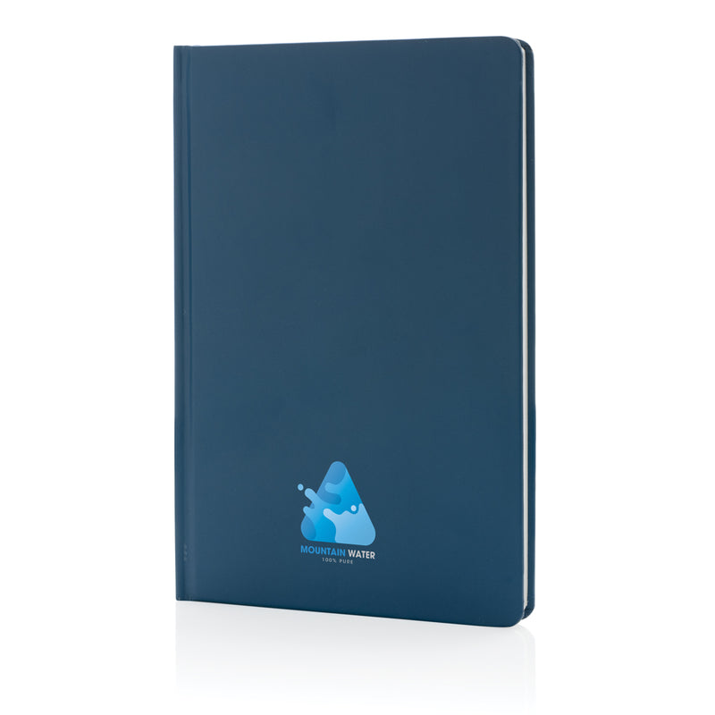 Load image into Gallery viewer, A5 Impact stone paper hardcover notebook from XD Collection with a sleek black cover and a pen resting on top.