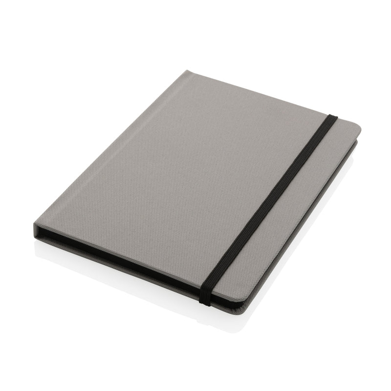 Load image into Gallery viewer, A green GRS certified RPET A5 notebook from XD Collection with a textured cover and spiral binding, suitable for writing and note-taking.