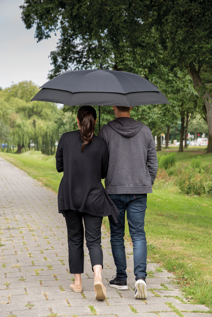 Load image into Gallery viewer, Swiss Peak 23-27 inch expandable umbrella opened, black canopy with silver handle, compact and lightweight travel umbrella.