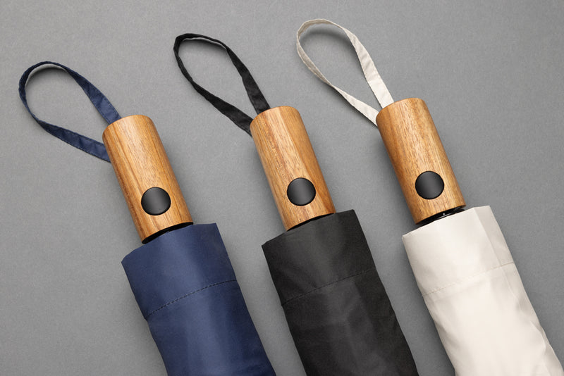 Load image into Gallery viewer, Kaycey 21-inch AWARE™ RPET acacia wood mini auto open umbrella by XD Collection, with a compact canopy and wooden handle.