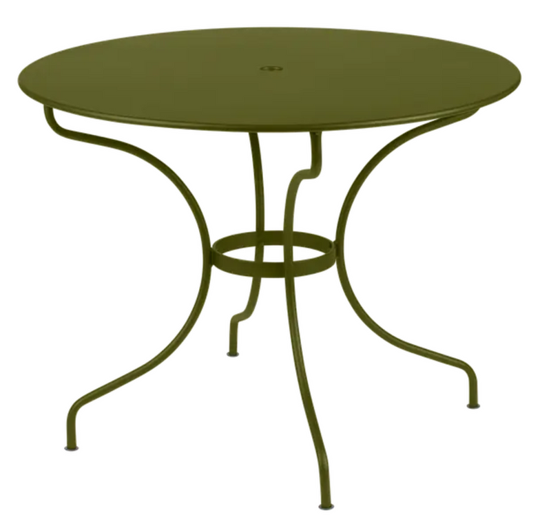 Load image into Gallery viewer, Fermob OPÉRA+ outdoor metal table with a 96 cm diameter, stylish five-seater design in a pesto finish on a patio.