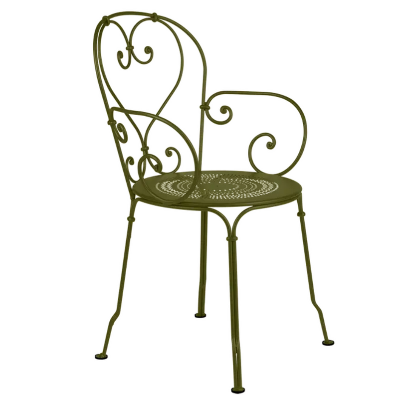 Load image into Gallery viewer, Fermob Pesto 1900 Lounge Armchair outdoors, featuring a modern design with a curved backrest and armrests for outdoor patio use.